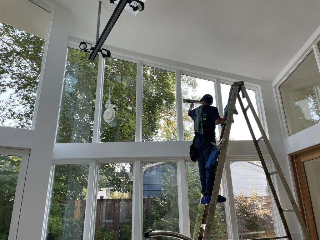 Windows Only crew cleaning tall inside windows from a ladder